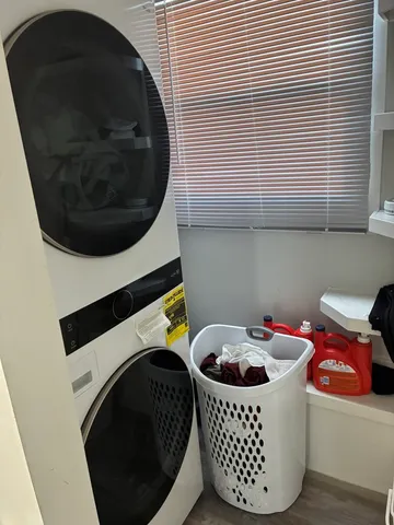 a bathroom with a washing machine and a washing machine