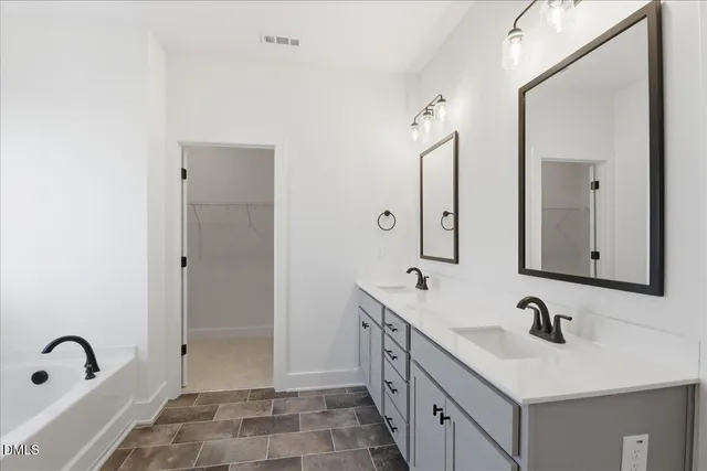 a bathroom with a double vanity sink and mirror