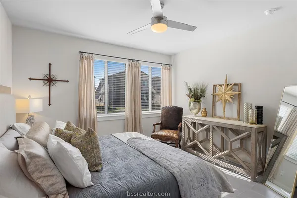 a bedroom with furniture and a large window