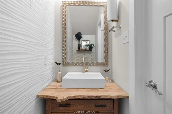 a bathroom with a sink and a mirror