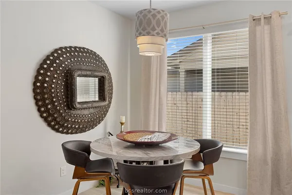 a view of a dining room with furniture and window