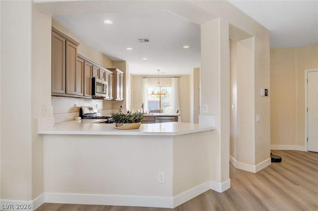 2649 Rue Marquette Avenue Henderson, NV 89044 - Photo 20 of 55 This kitchen showcases a functional layout with ample counter space and well-appointed cabinetry.