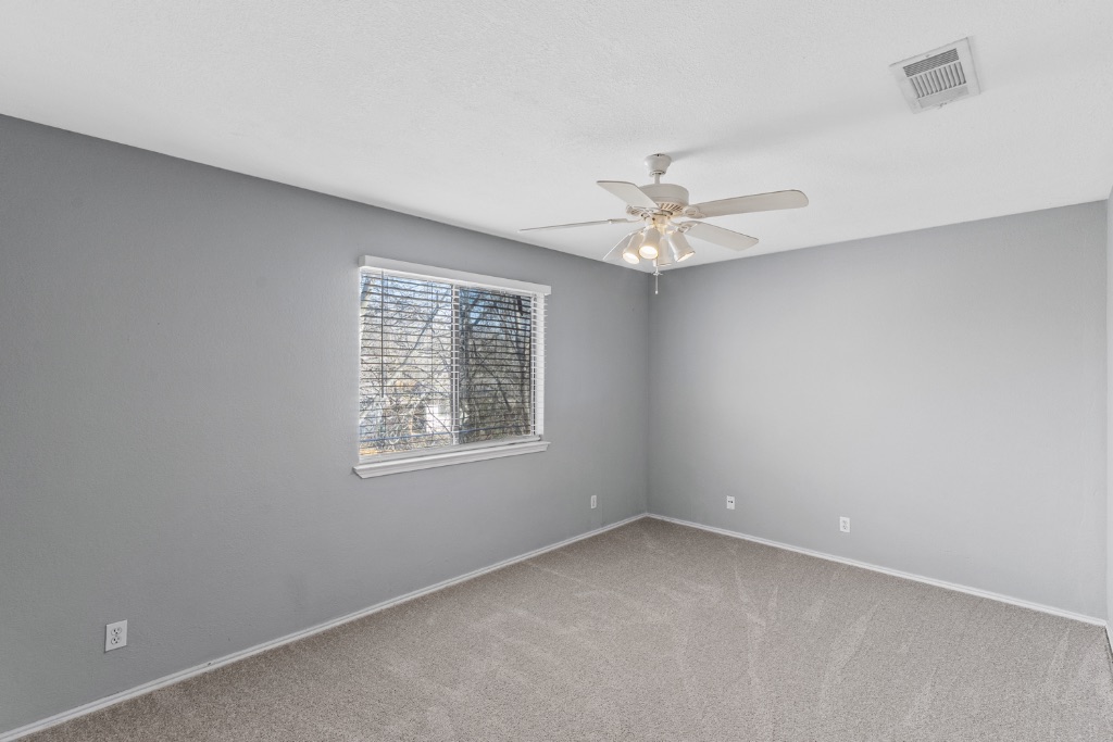 9203 Kempler Drive, Unit B Austin, TX 78748 - Photo 20 of 26 an empty room with a window and a ceiling fan