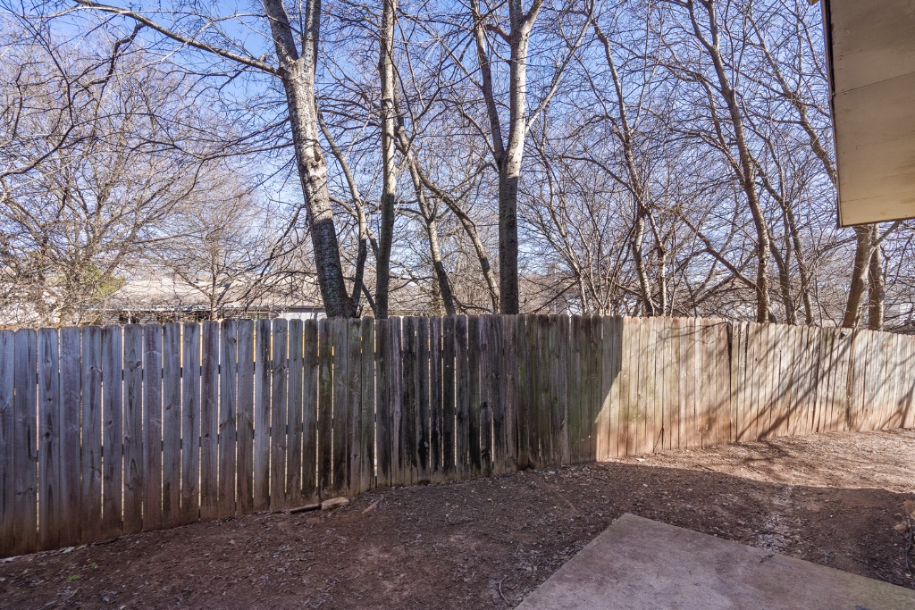 9203 Kempler Drive, Unit B Austin, TX 78748 - Photo 24 of 26 a wooden fence covered with tall trees