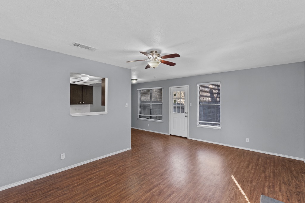 9203 Kempler Drive, Unit B Austin, TX 78748 - Photo 8 of 26 a view of an empty room with a window and wooden floor