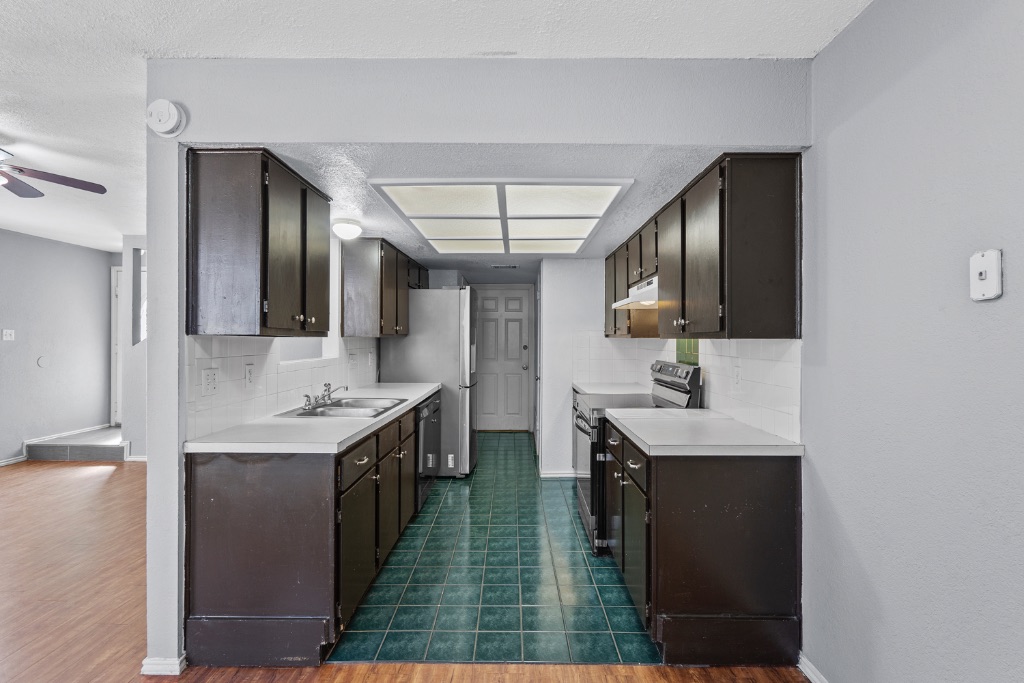 9203 Kempler Drive, Unit B Austin, TX 78748 - Photo 10 of 26 a kitchen with sink stove and cabinets