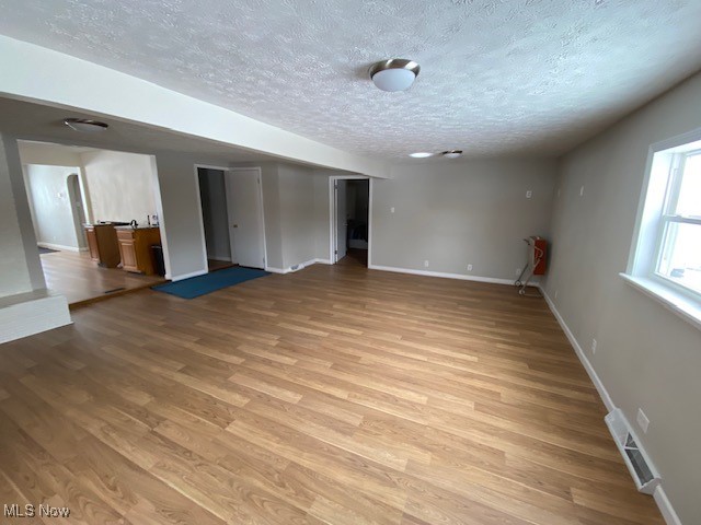 1027 Bantam Ridge Road Steubenville, OH 43953 - Photo 7 of 18 Spare room featuring a textured ceiling and light hardwood / wood-style flooring