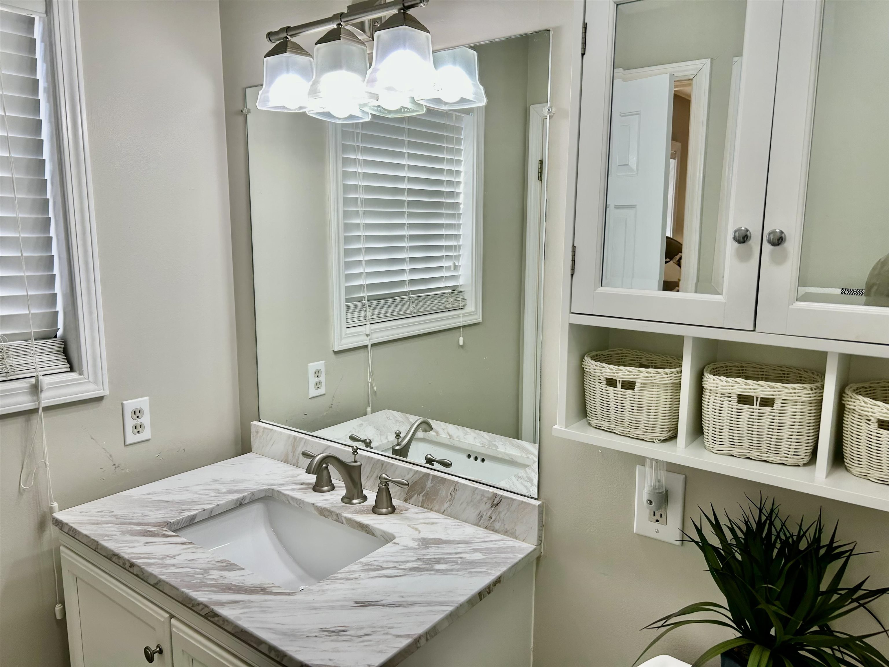 95 Blade Bay, Unit BAY Counce, TN 38326 - Photo 11 of 21 a bathroom with a granite countertop sink a mirror and vanity