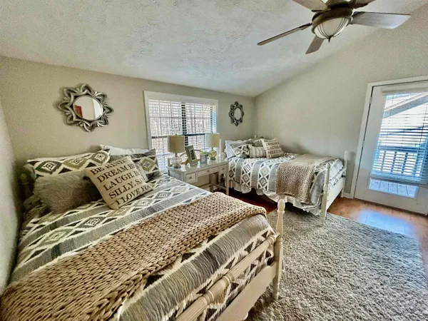 a bedroom with two beds and a window