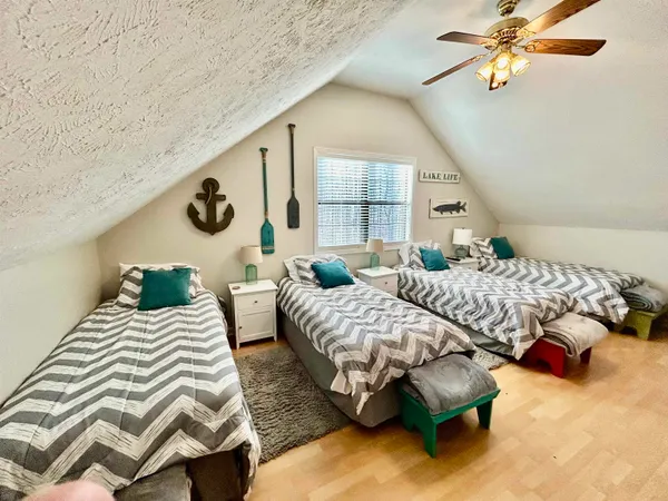 a bedroom with bed and a window