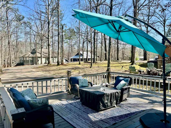 a balcony with furniture and umbrella