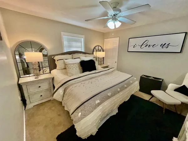a bedroom with a bed and ceiling fan