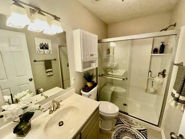 a bathroom with a sink toilet and shower