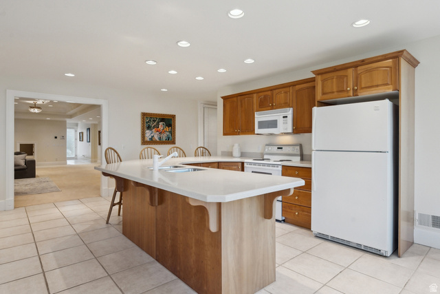 1714 Ridge Point Drive Bountiful, UT 84010 - Photo 78 of 132 Kitchen featuring wood cabinetry, white appliances, recessed lighting, and tile flooring