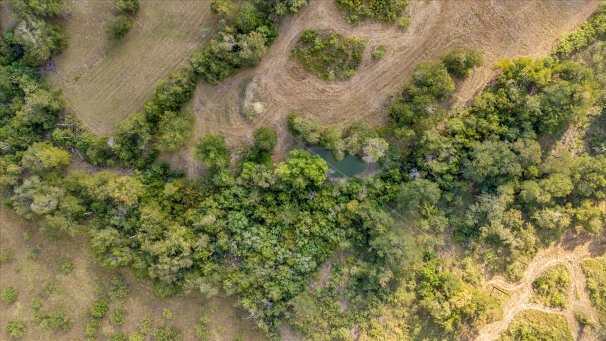 Tbd Hibbs Lane Manor, TX 78653 - Photo 4 of 12 an aerial view of residential house with outdoor space and trees all around