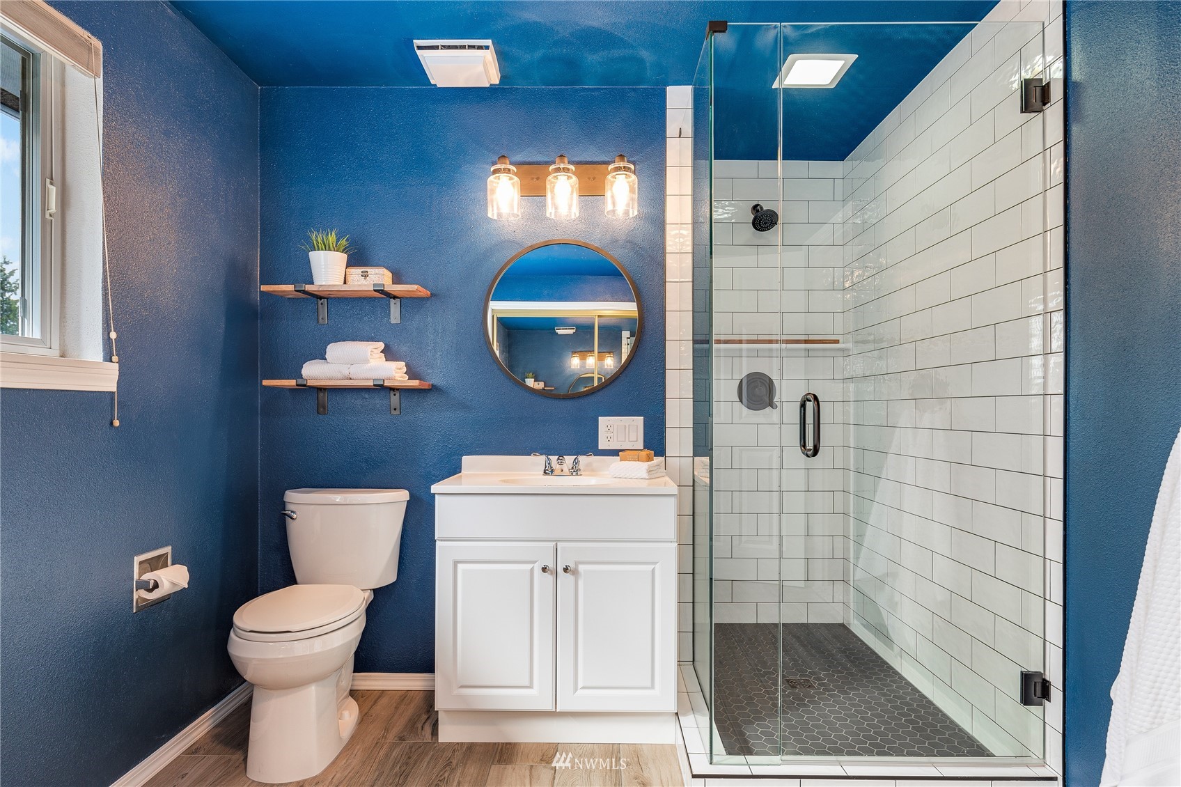 504 240th Street Southwest Bothell, WA 98021 - Photo 16 of 40 a bathroom with a toilet a sink and mirror
