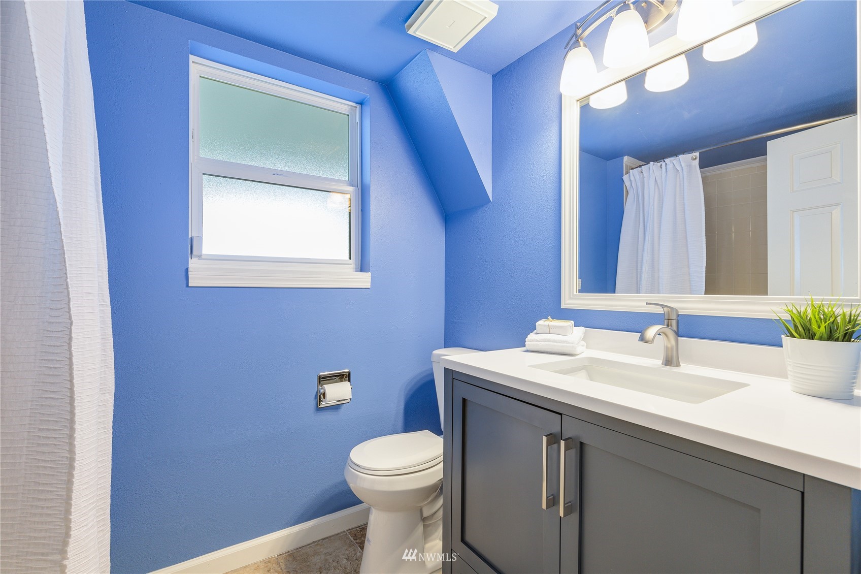 504 240th Street Southwest Bothell, WA 98021 - Photo 25 of 40 a bathroom with a toilet sink and mirror