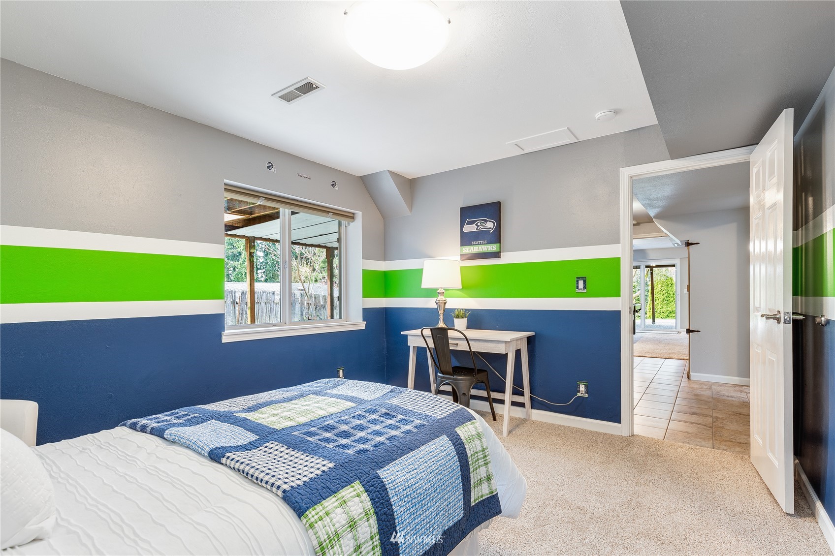 504 240th Street Southwest Bothell, WA 98021 - Photo 27 of 40 a bedroom with a bed and a table and chair