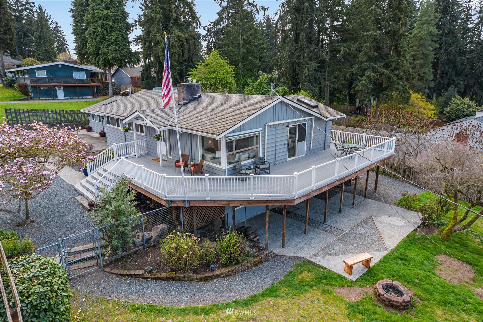504 240th Street Southwest Bothell, WA 98021 - Photo 38 of 40 a terrace of a house with table and chairs potted plants