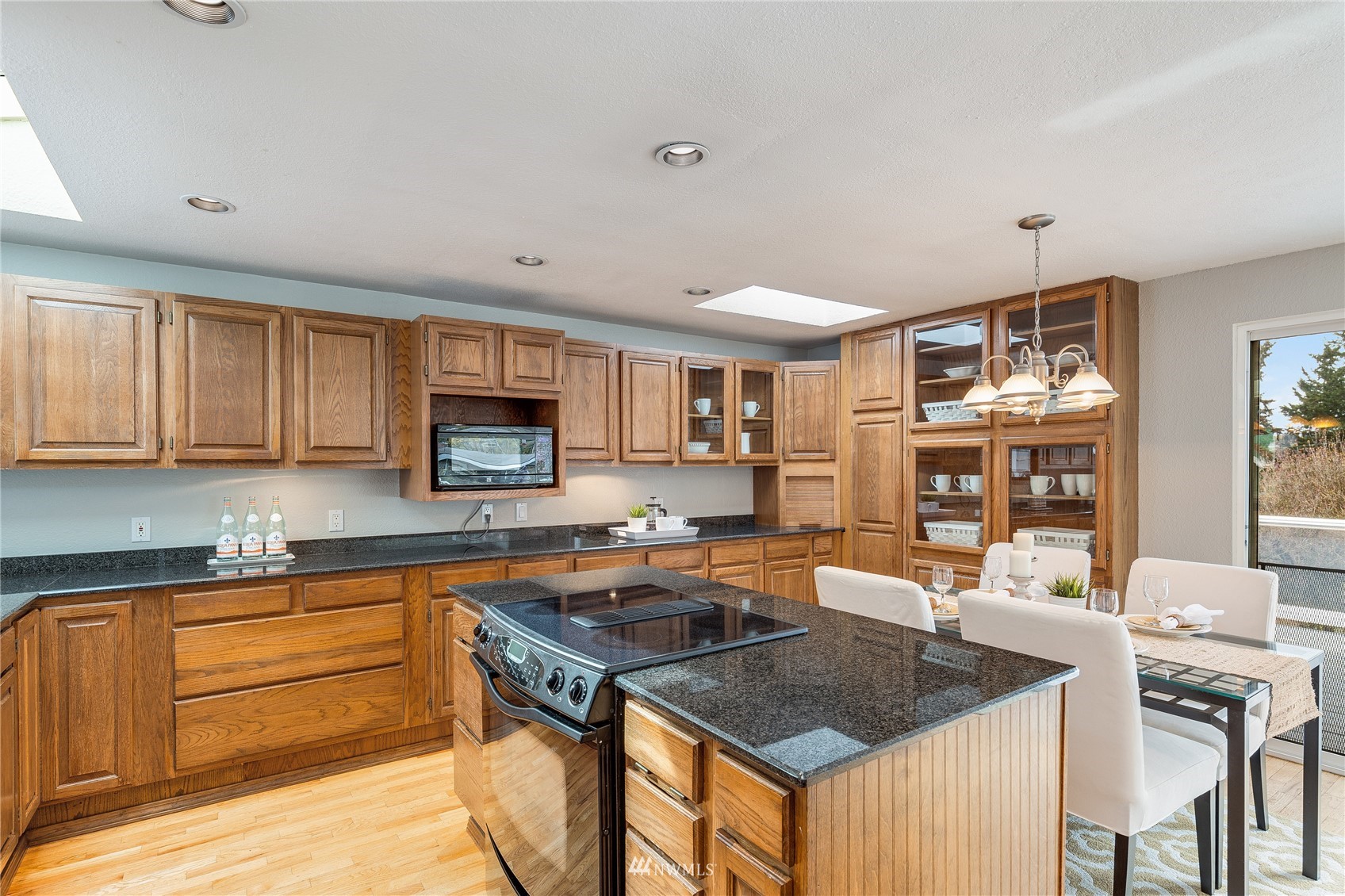 504 240th Street Southwest Bothell, WA 98021 - Photo 9 of 40 a kitchen with stainless steel appliances granite countertop a sink stove and refrigerator