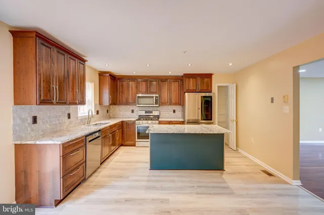 a kitchen with stainless steel appliances granite countertop a sink and cabinets