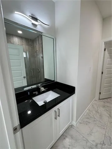 a bathroom with a sink a vanity and a mirror