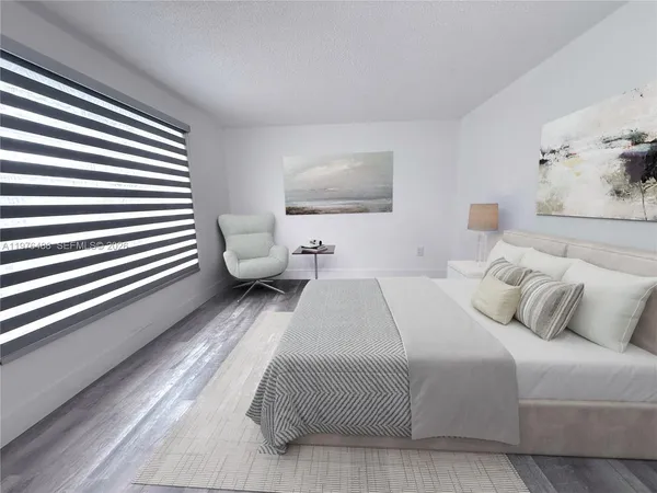 a bedroom with a bed and a painting on the wall
