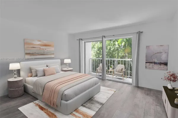 a bedroom with a large bed and a balcony view