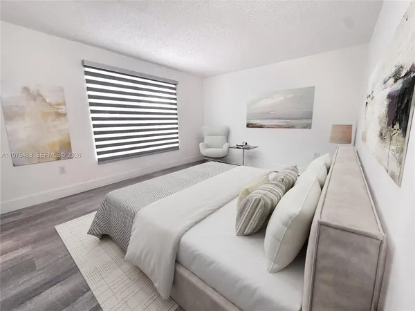 a bedroom with a bed and a painting on the wall