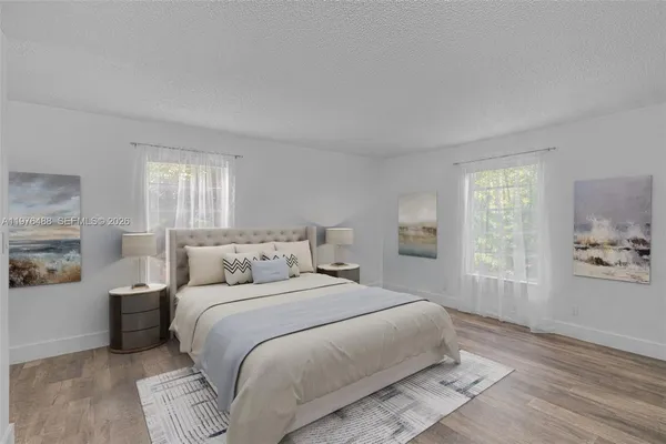 a bedroom with a large bed and a window