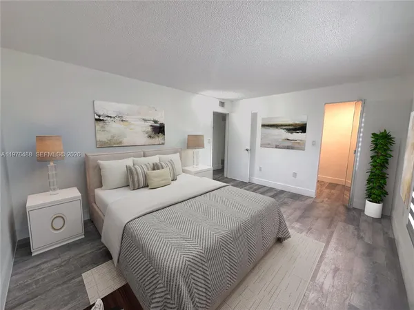 a kitchen with stainless steel appliances a refrigerator sink and white cabinets
