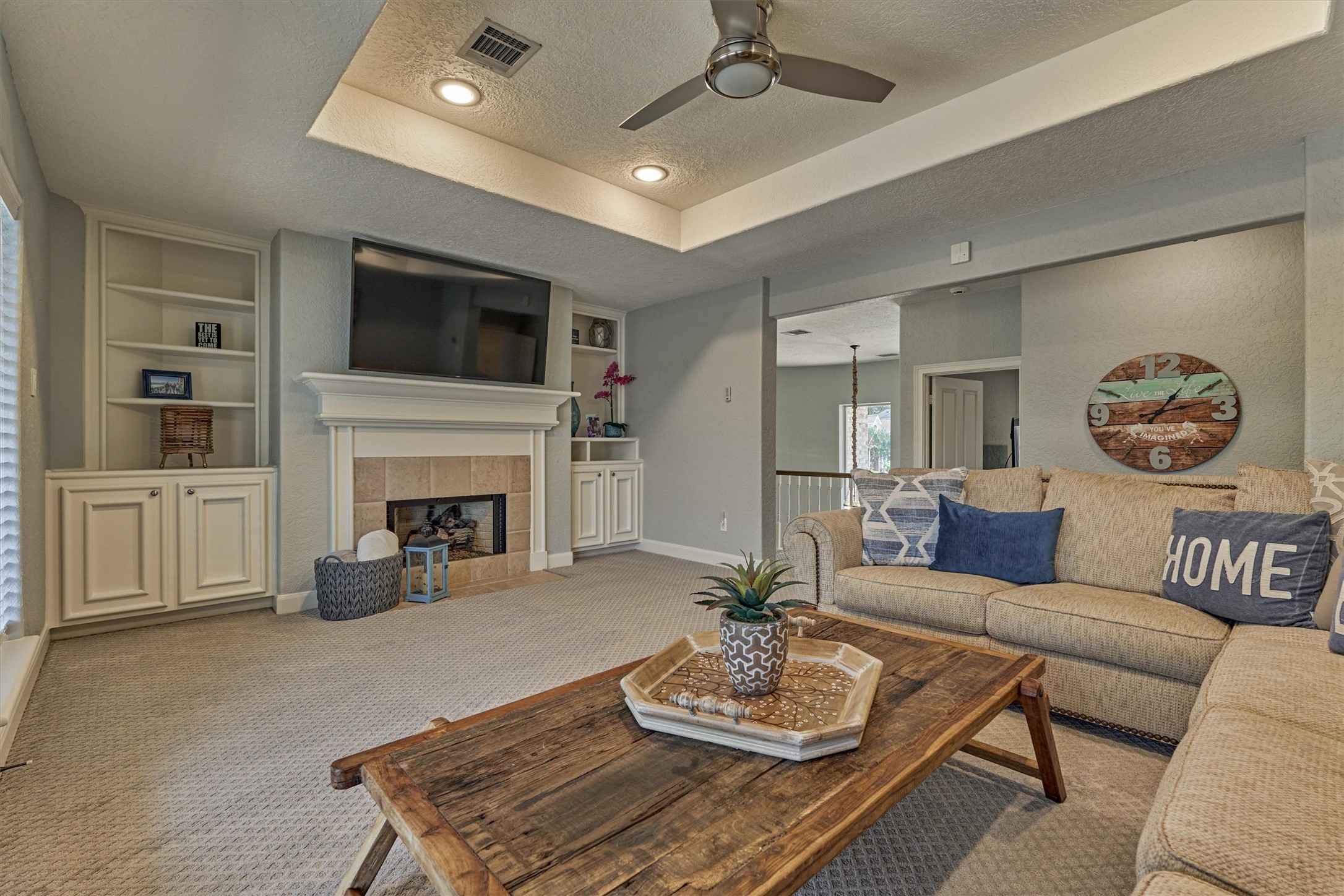 202 Edgemar Road Montgomery, TX 77356 - Photo 33 of 50 Thoughtfully designed game room with custom built-ins for games, books, and more. A second gas-log fireplace with tile surround adds warmth, while French doors open to a balcony overlooking the serene lake.