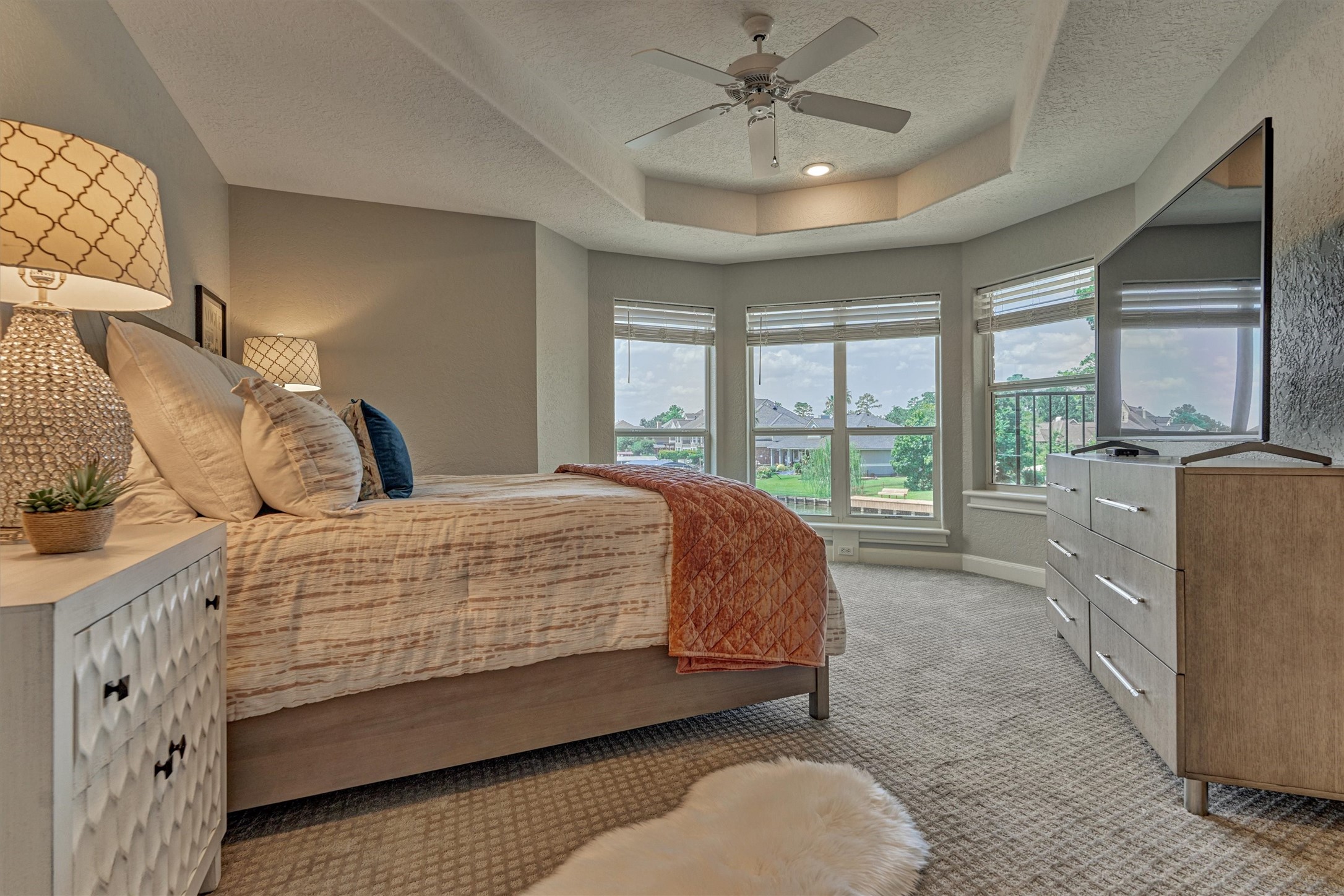 202 Edgemar Road Montgomery, TX 77356 - Photo 36 of 50 Wake up to sweeping lake views from this spacious upstairs bedroom, complete with bay windows, tray ceiling and ceiling fan and en suite bathroom.