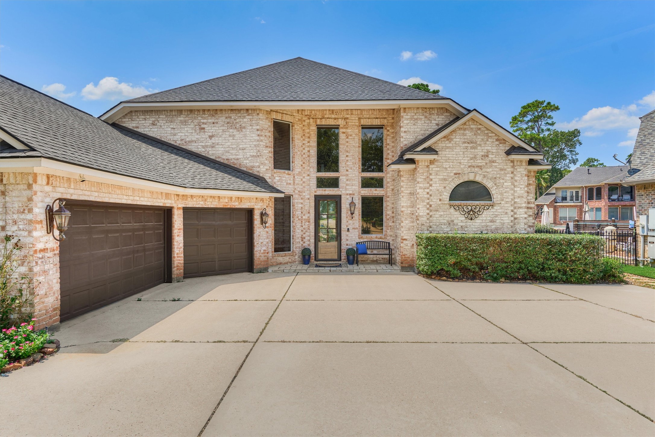 202 Edgemar Road Montgomery, TX 77356 - Photo 4 of 50 A double-wide driveway leads to the three-car garage, while the timeless brick façade, large windows, and custom glass storm door set the tone for classic elegance. Lush landscaping and undeniable curb appeal complete the exterior.