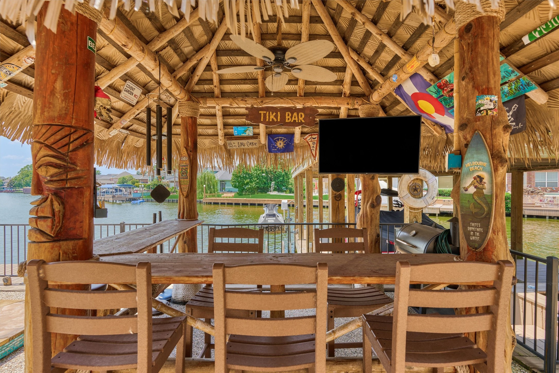 202 Edgemar Road Montgomery, TX 77356 - Photo 46 of 50 Unwind in the shade of your Margaritaville-style tiki hut—perfect for cocktails and lakefront leisure.