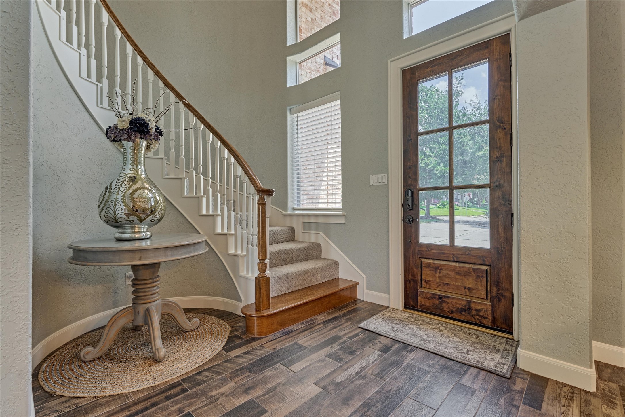202 Edgemar Road Montgomery, TX 77356 - Photo 9 of 50 Elegant curved staircase and wood-look flooring set the tone for timeless style.