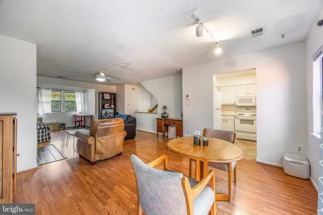 a living room with fireplace furniture and a wooden floor