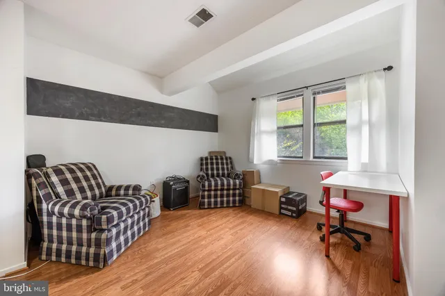 a livingroom with workspace and a window