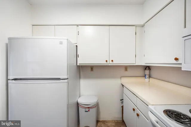 a view of a storage and utility room with washer and dryer