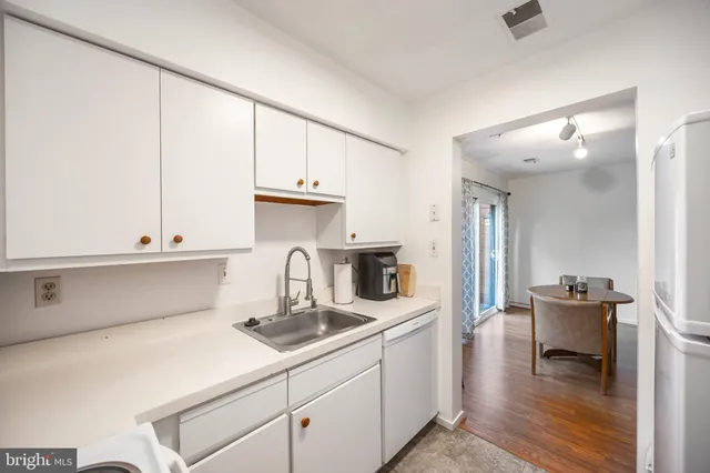 a kitchen with a sink cabinets and appliances