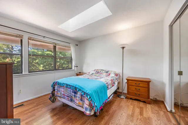 a bedroom with a bed and a mirror