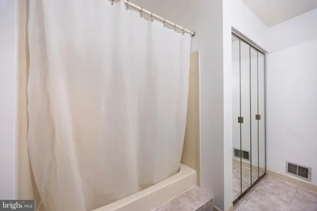 a bathroom with a shower and a tub