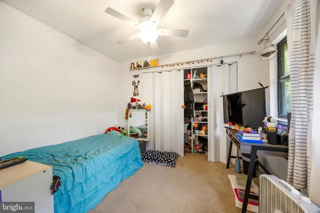 a bedroom with furniture and a flat screen tv