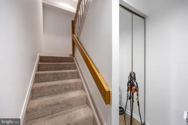 a view of staircase with white walls and a window