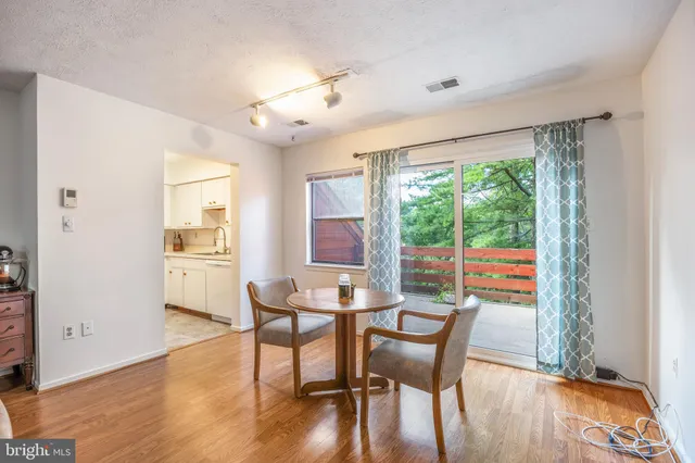 a dining room with furniture and wooden floor