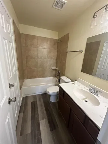 a bathroom with a double vanity sink toilet and shower