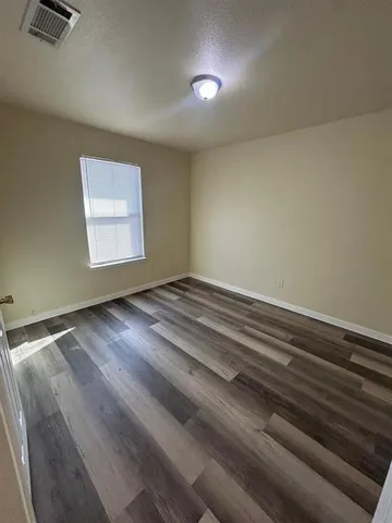 a view of room with window and hardwood floor