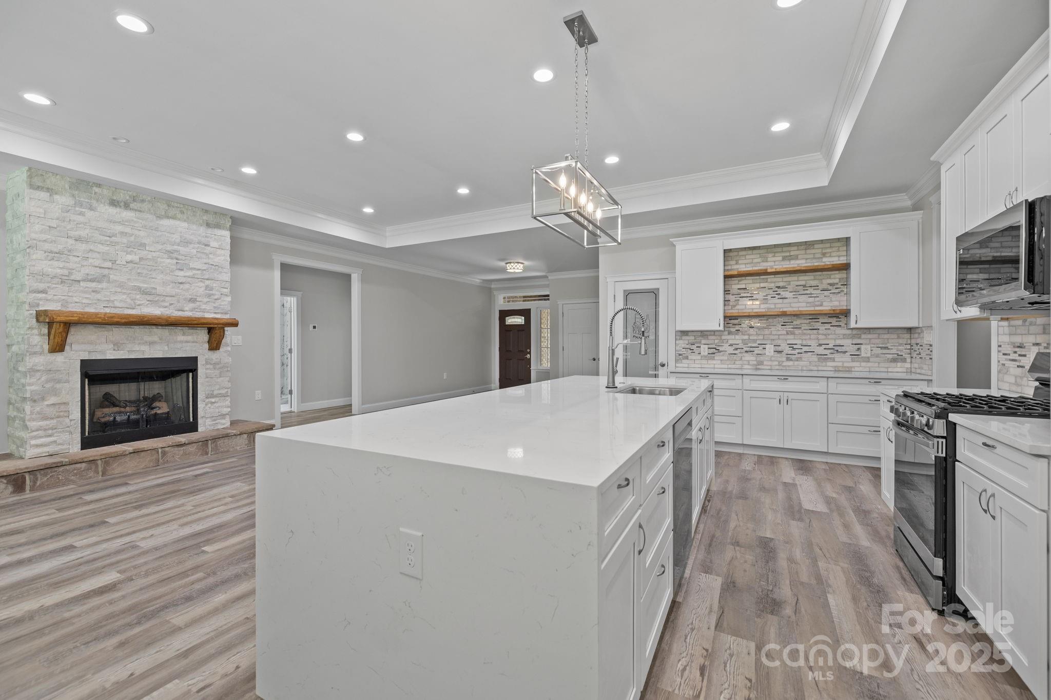 4531 Deer Run Rock Hill, SC 29732 - Photo 12 of 32 a large white kitchen with stainless steel appliances granite countertop a stove a sink dishwasher and a refrigerator with wooden floor