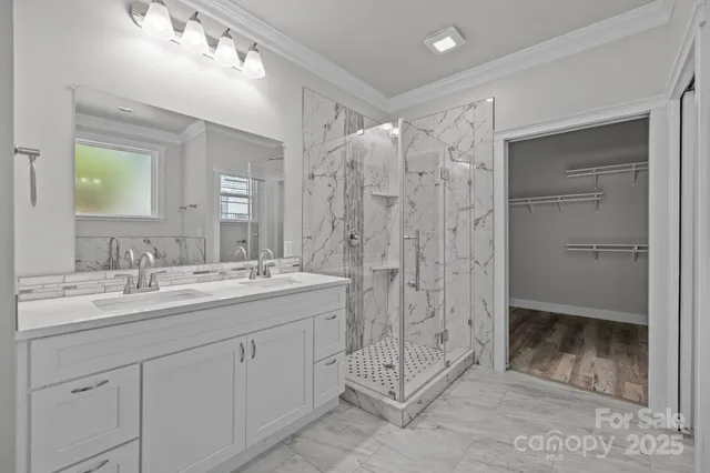 a bathroom with a shower sink and mirror