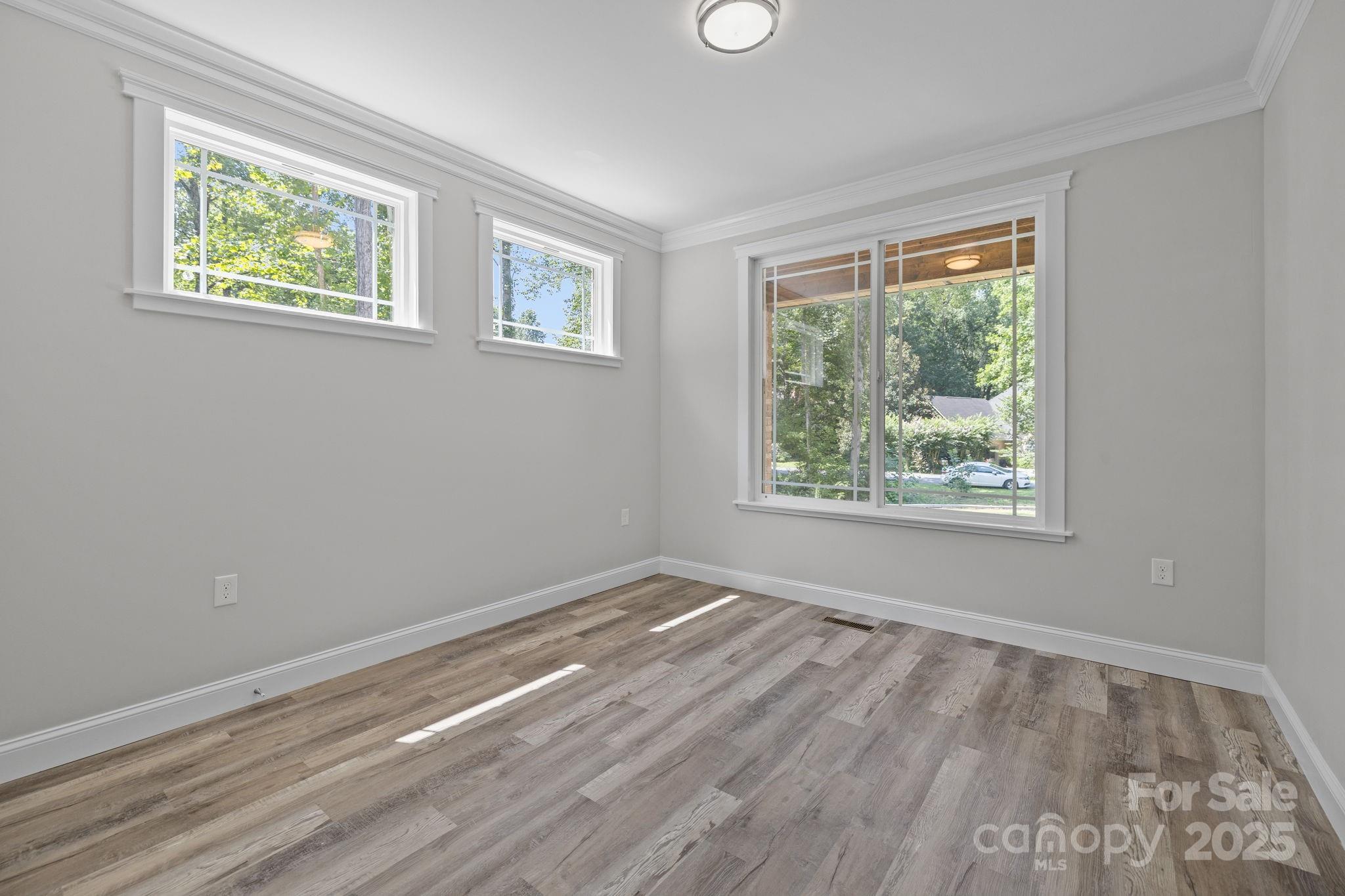 4531 Deer Run Rock Hill, SC 29732 - Photo 20 of 32 a view of an empty room with wooden floor and a window